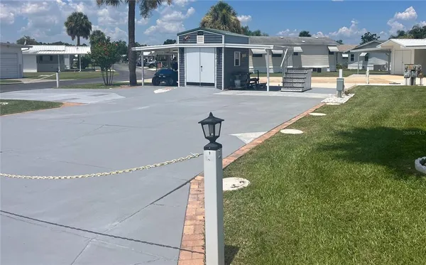 a swimming pool view with a seating space and a park view
