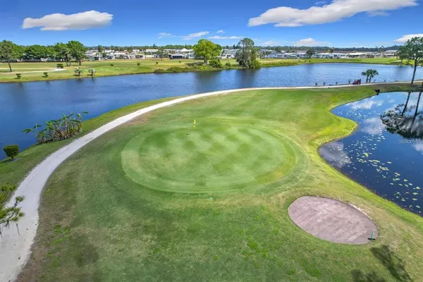 an aerial view of residential houses with outdoor space and lake view