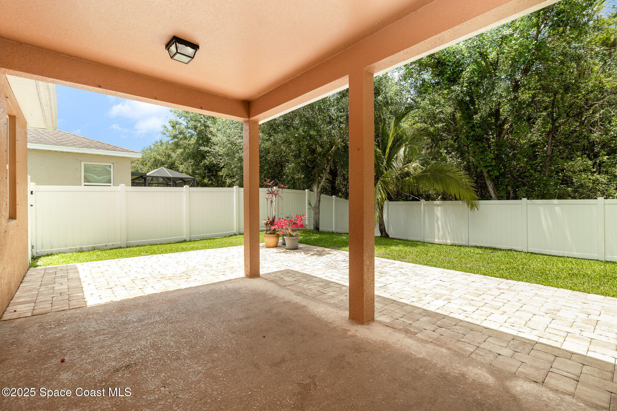 122 Port Royal Court Sebastian, FL 32958 - Photo 20 of 26 a view of a room with a floor to ceiling window next to a yard