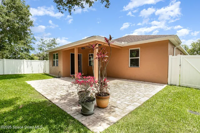 a front view of a house with a garden and yard