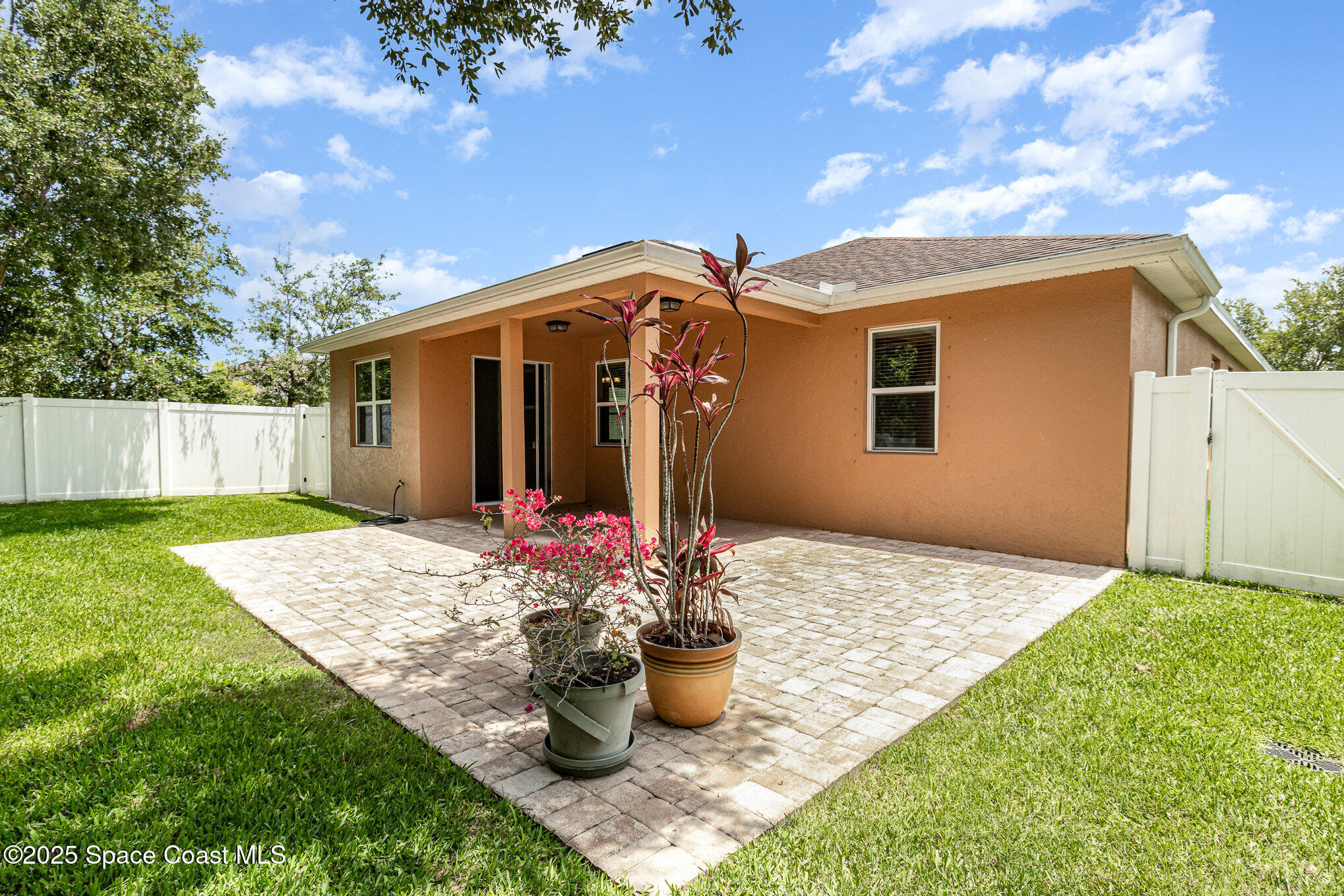 122 Port Royal Court Sebastian, FL 32958 - Photo 22 of 26 a front view of a house with a garden and yard