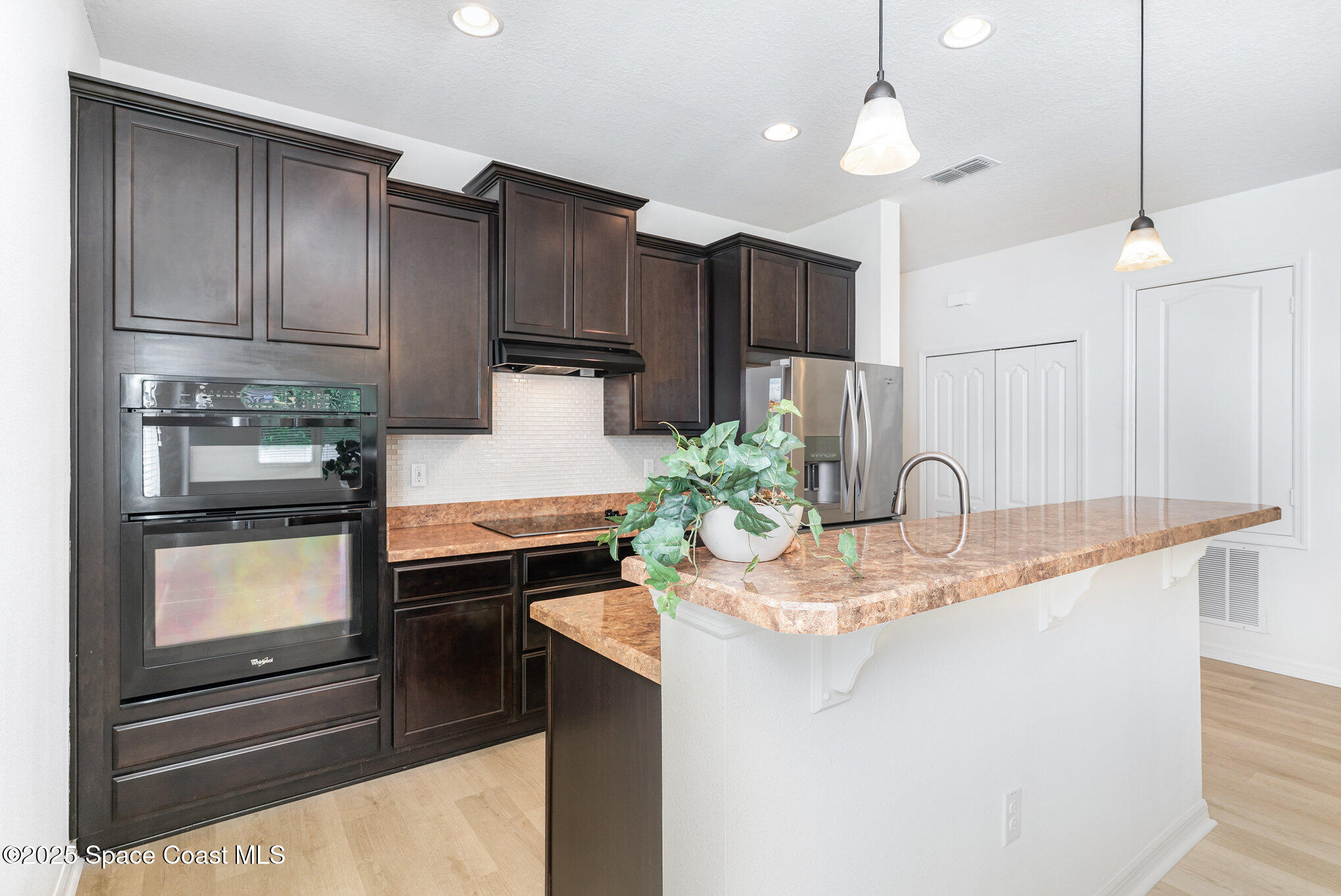 122 Port Royal Court Sebastian, FL 32958 - Photo 3 of 26 a kitchen with kitchen island granite countertop a sink cabinets and stainless steel appliances