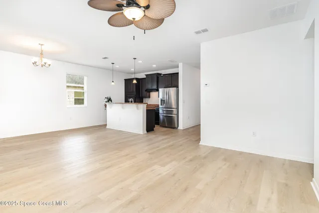 a view of a kitchen with a sink and a refrigerator