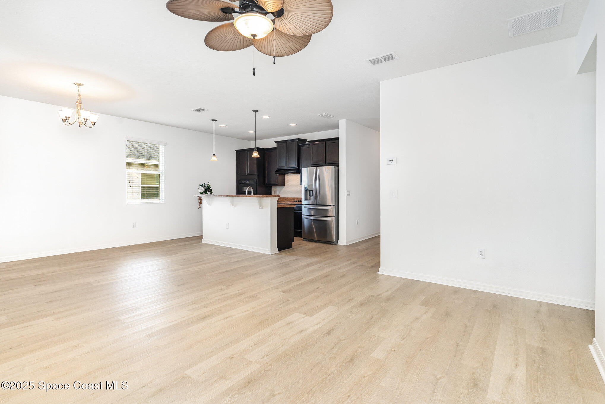 122 Port Royal Court Sebastian, FL 32958 - Photo 6 of 26 a view of a kitchen with a sink and a refrigerator