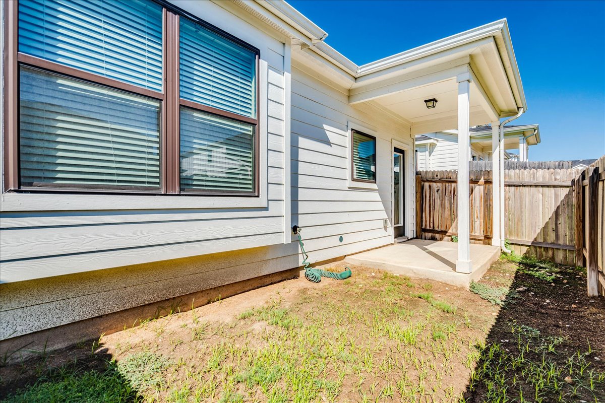 144 Threshing Road, Unit A Buda, TX 78610 - Photo 31 of 35 Back patio fenced with wood privacy fencing.