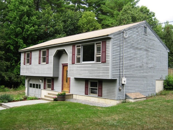 64 Colburn Road Milford, NH 03055 - Photo 2 of 17 a front view of a house with a garden and chairs