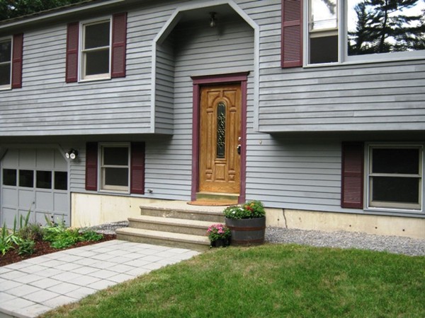 64 Colburn Road Milford, NH 03055 - Photo 4 of 17 a view of a house with a small yard and a large window