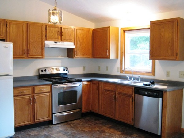 64 Colburn Road Milford, NH 03055 - Photo 7 of 17 a kitchen with stainless steel appliances granite countertop a sink a stove and a refrigerator