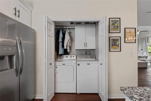 a kitchen with cabinets and wooden floor
