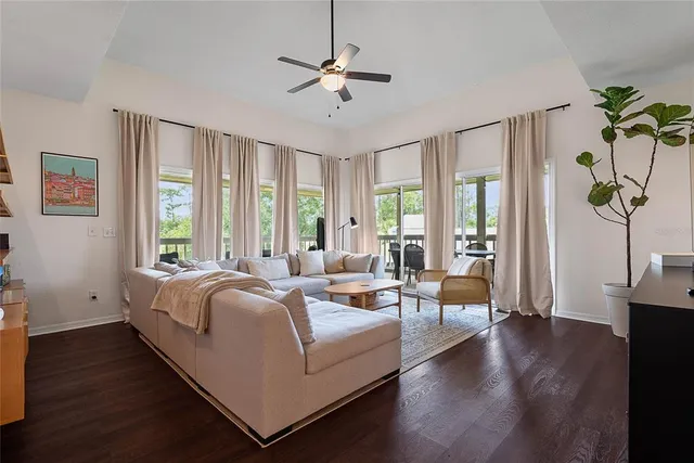 a living room with bed furniture and a large window