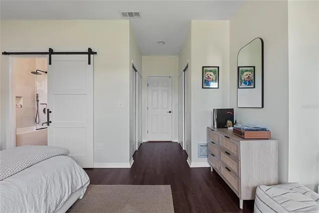 a bedroom with a bed and a desk