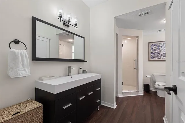 a bathroom with a double vanity sink mirror and bathtub