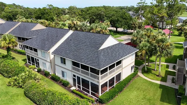 a aerial view of a house with a yard table and chairs