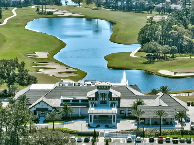 an aerial view of a house with swimming pool a yard and outdoor seating