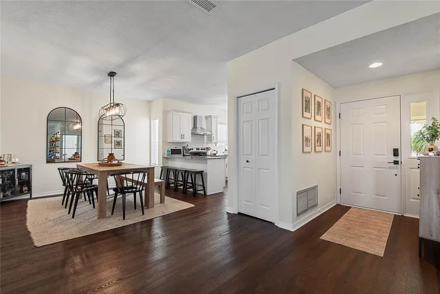 a view of a a dining room with furniture window and wooden floor
