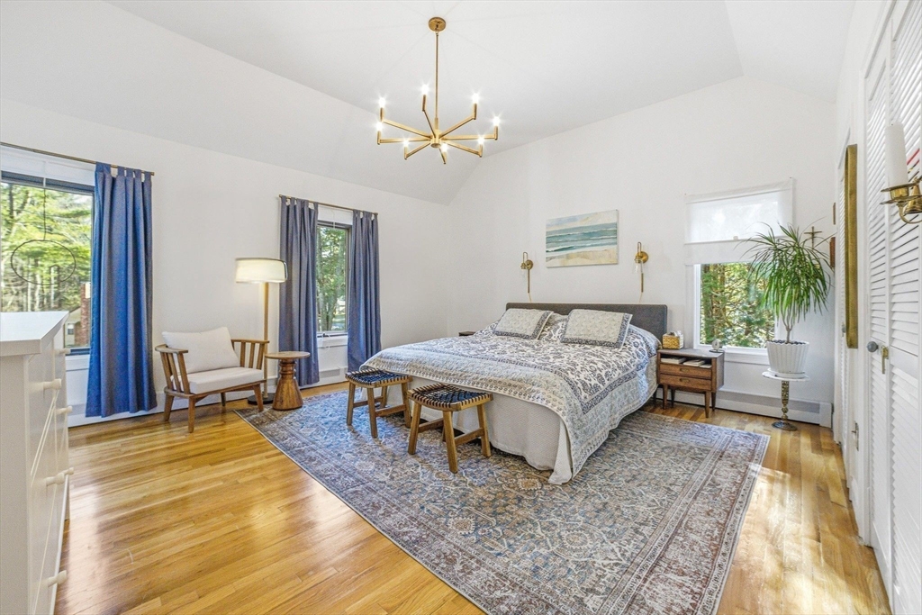6 Montaup Road, Unit 6 Sharon, MA 02067 - Photo 14 of 35 a spacious bedroom with a large bed and a chandelier