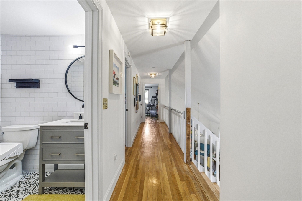 6 Montaup Road, Unit 6 Sharon, MA 02067 - Photo 22 of 35 a view of a hallway with wooden floor and a bathroom