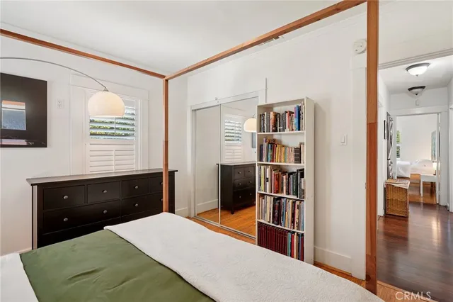 a bedroom with a bed and a book shelf