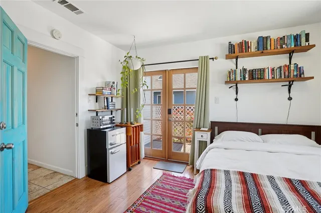 a bedroom with a bed and a book shelf
