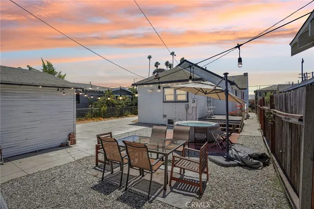 a view of a house with backyard and sitting area