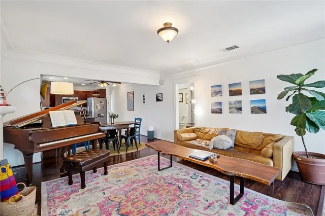 a living room with furniture and a piano