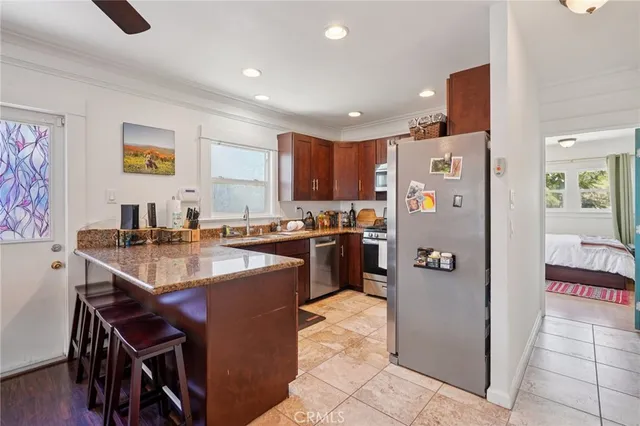 a kitchen with a sink refrigerator and cabinets