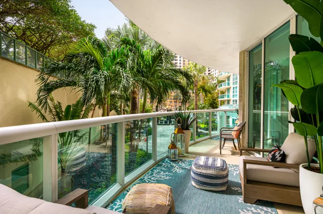 a view of a chair and tables in the balcony
