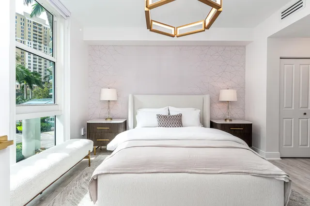 a large white bed in a white room