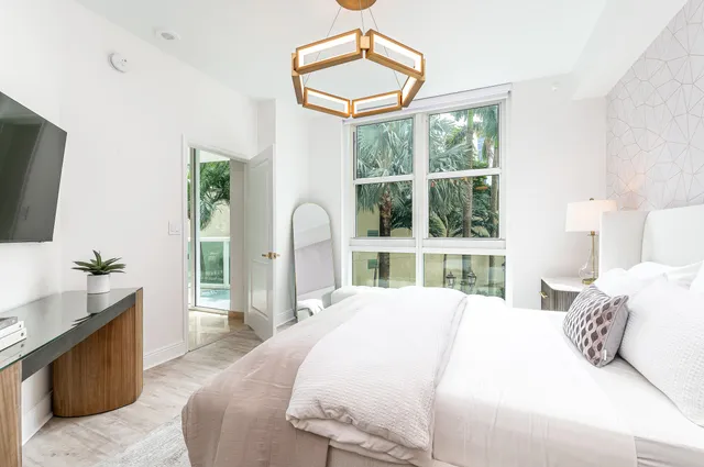 a bedroom with a bed and large window