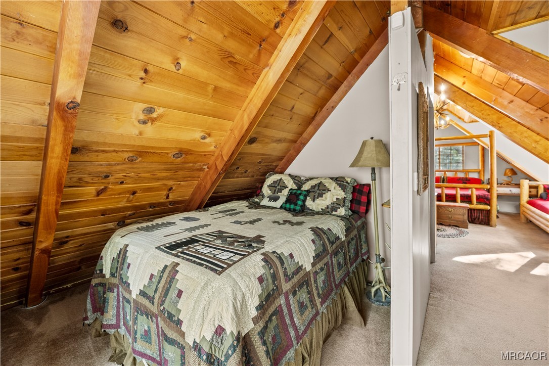 1289 Canyon Road Fawnskin, CA 92333 - Photo 9 of 23 a bed sitting in a bedroom next to a window