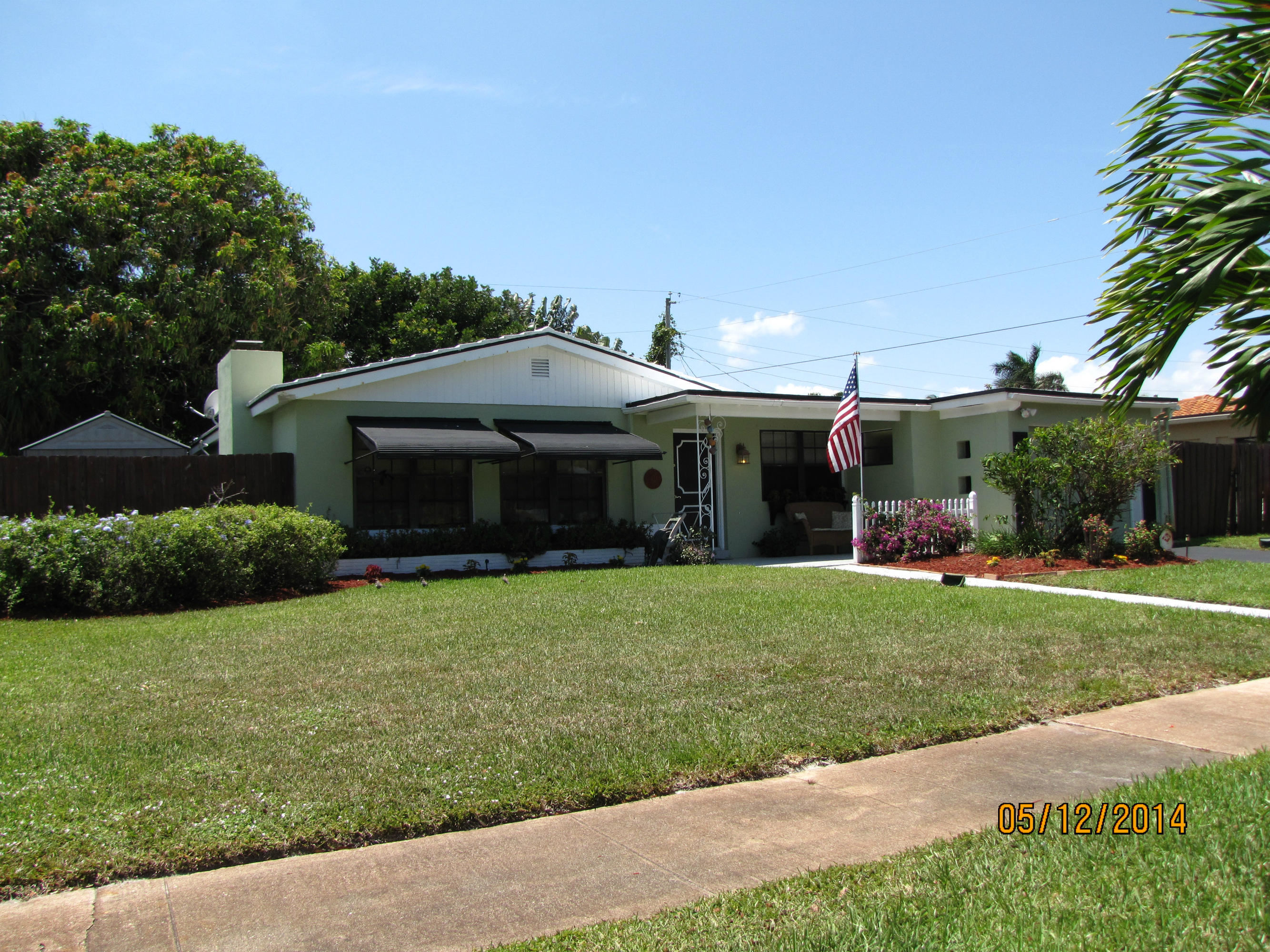 2145 Northeast 4th Way Boca Raton, FL 33431 - Photo 2 of 41 a front view of a house with a garden