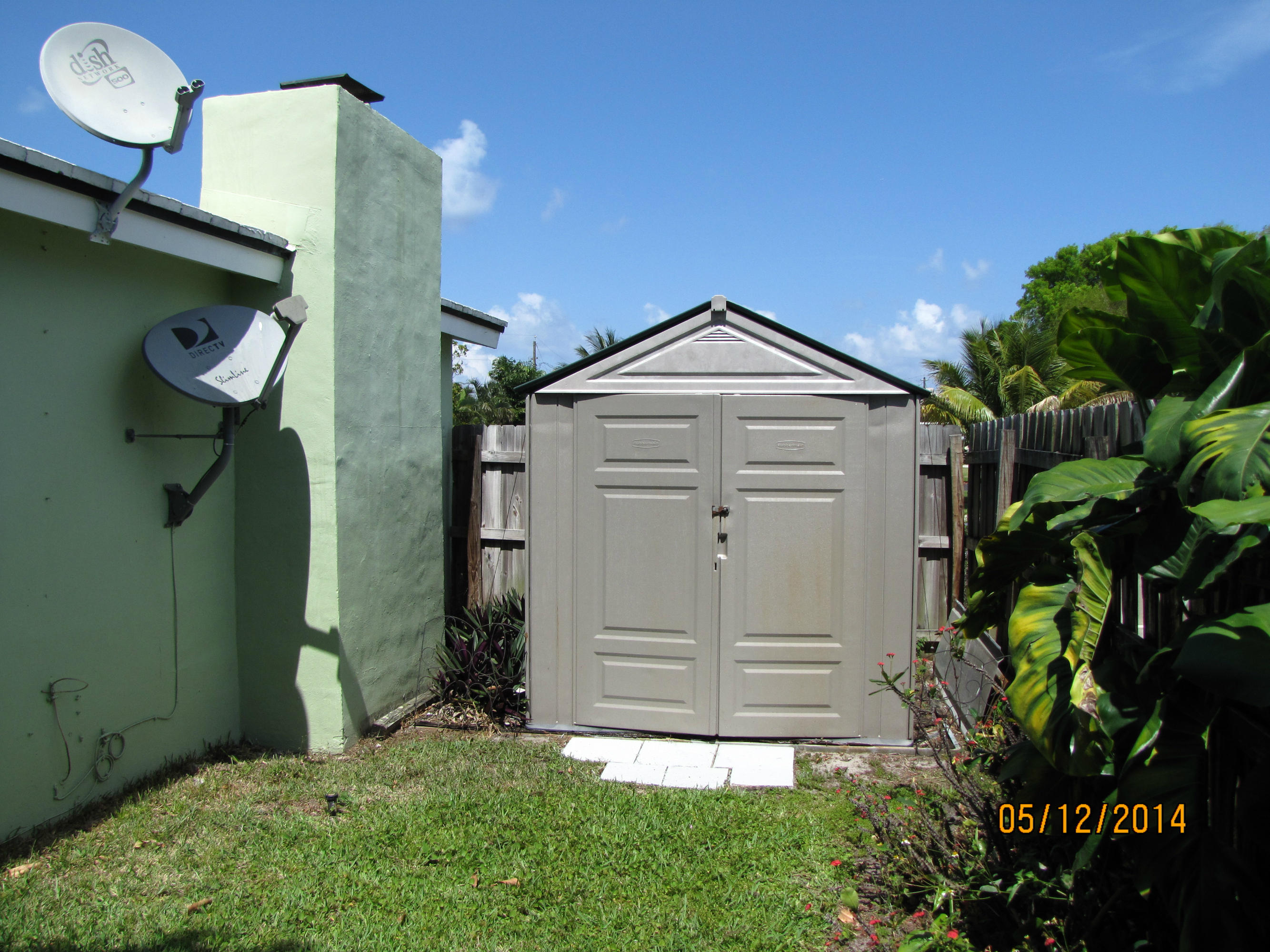 2145 Northeast 4th Way Boca Raton, FL 33431 - Photo 6 of 41 a front view of a house with a yard