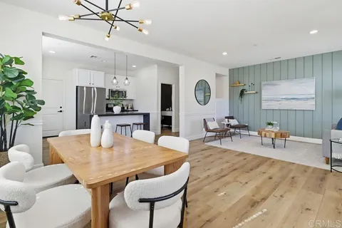 a view of a a dining room with furniture window and wooden floor