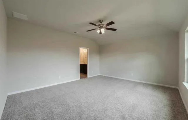 a view of an empty room with a ceiling fan