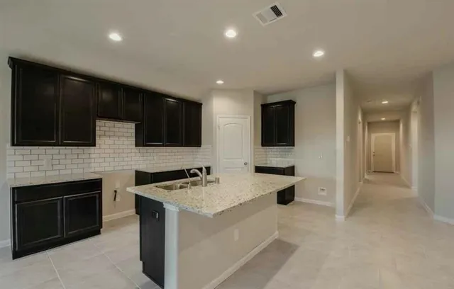 a kitchen with stainless steel appliances a stove sink microwave and cabinets