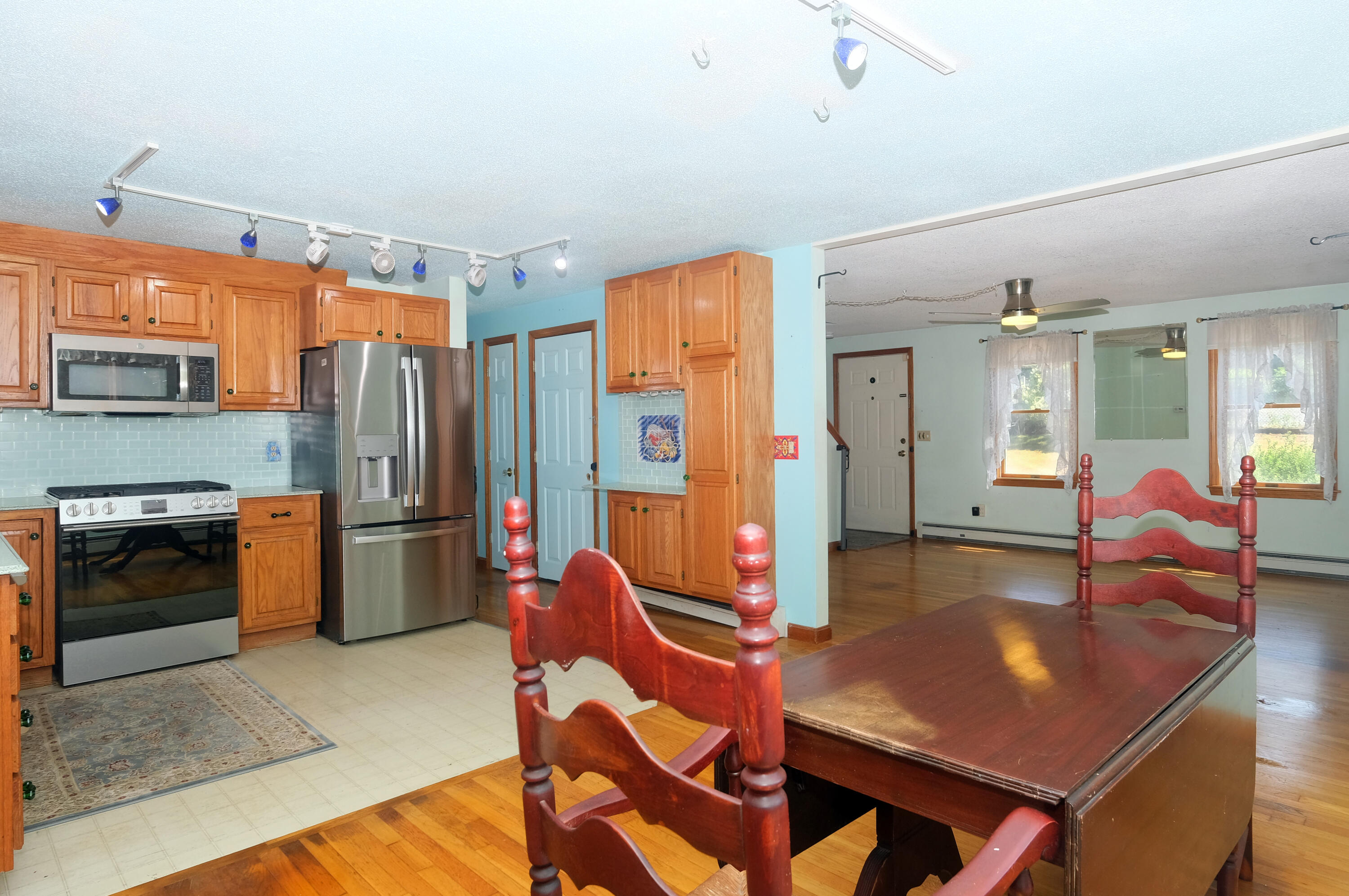 16 Partridge Lane Harwich, MA 02645 - Photo 14 of 44 a living room with stainless steel appliances furniture a rug and a kitchen view