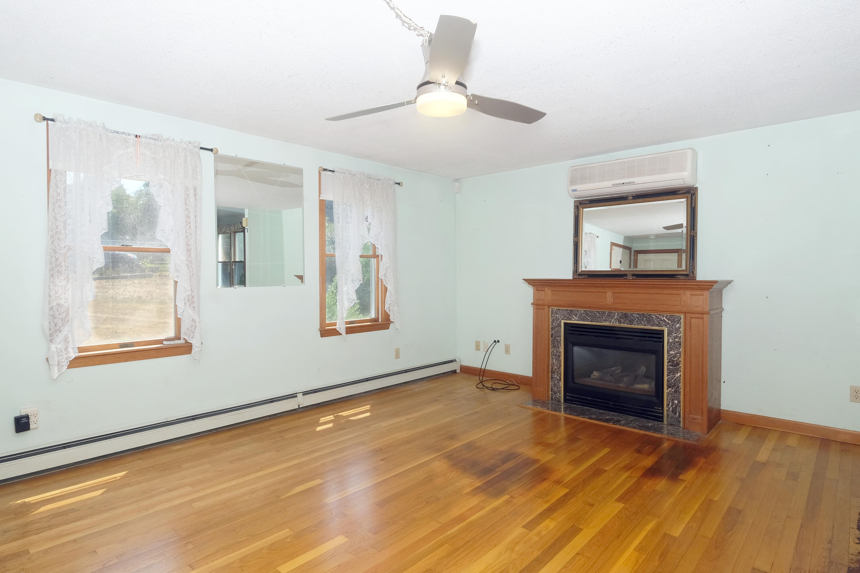 16 Partridge Lane Harwich, MA 02645 - Photo 5 of 44 a view of an empty room with window and fire place