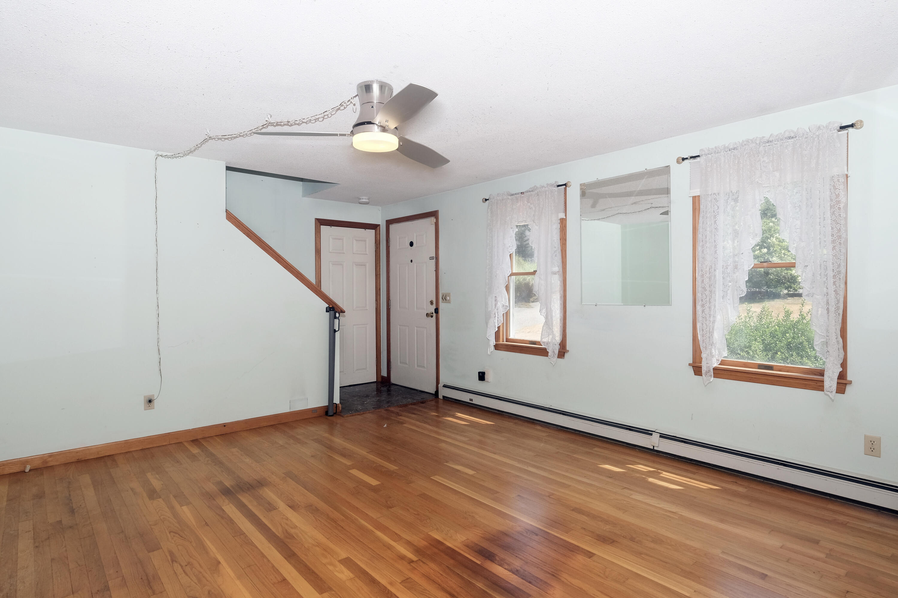 16 Partridge Lane Harwich, MA 02645 - Photo 6 of 44 a view of an empty room with wooden floor and a window