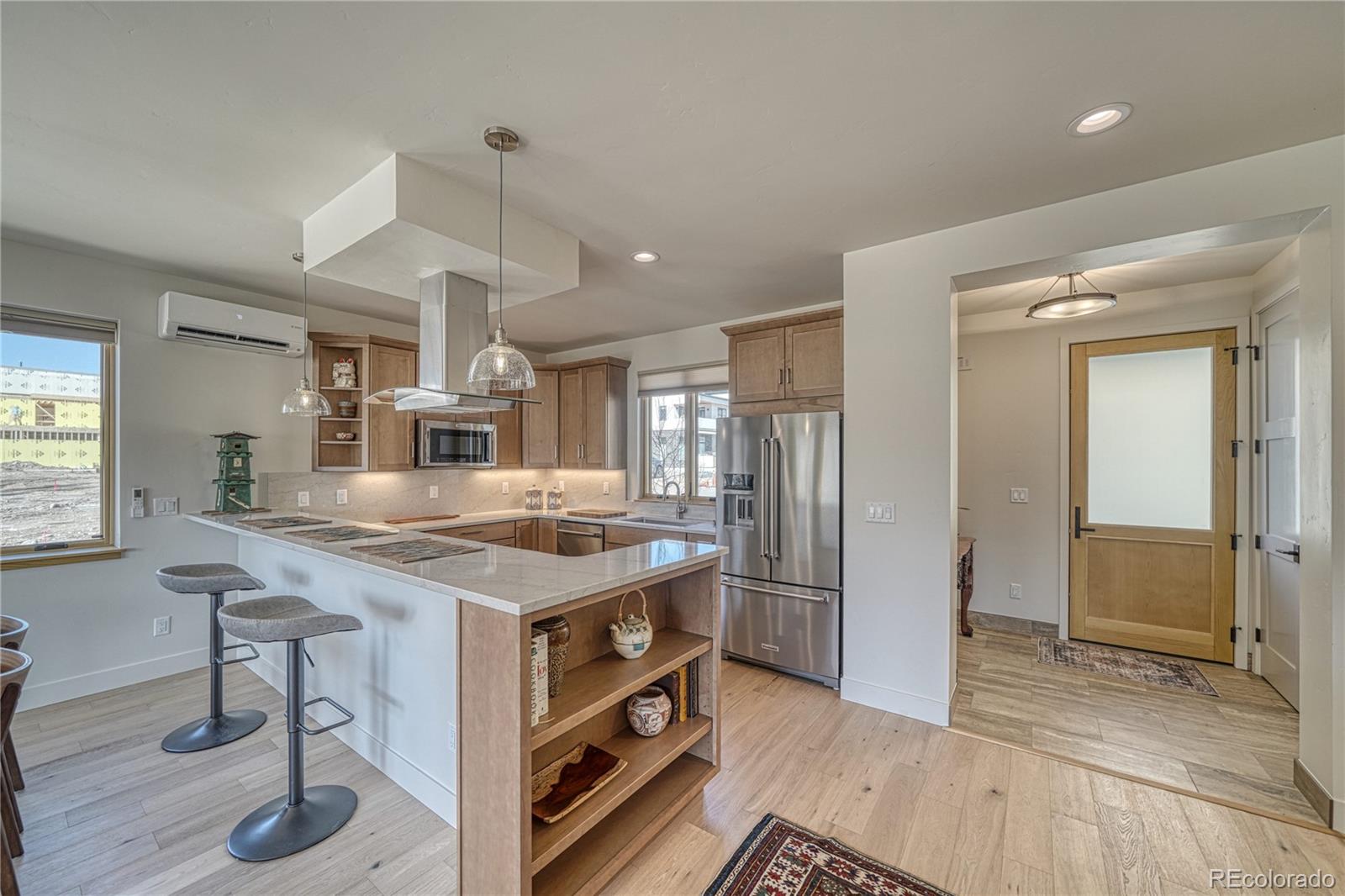205 Two Rivers Road, Unit G Salida, CO 81201 - Photo 11 of 29 a kitchen with stainless steel appliances granite countertop a stove and a refrigerator