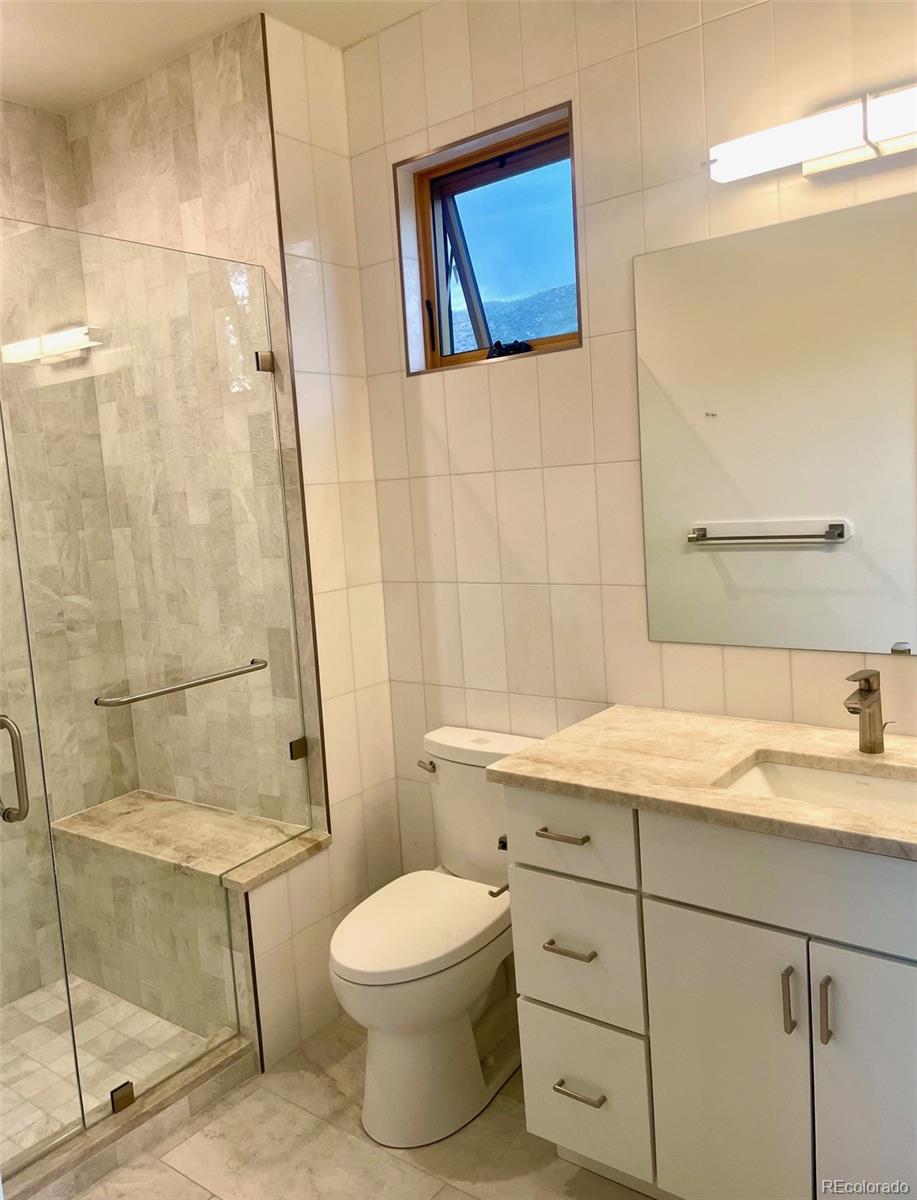 205 Two Rivers Road, Unit G Salida, CO 81201 - Photo 16 of 29 a bathroom with a granite countertop sink toilet a mirror and shower