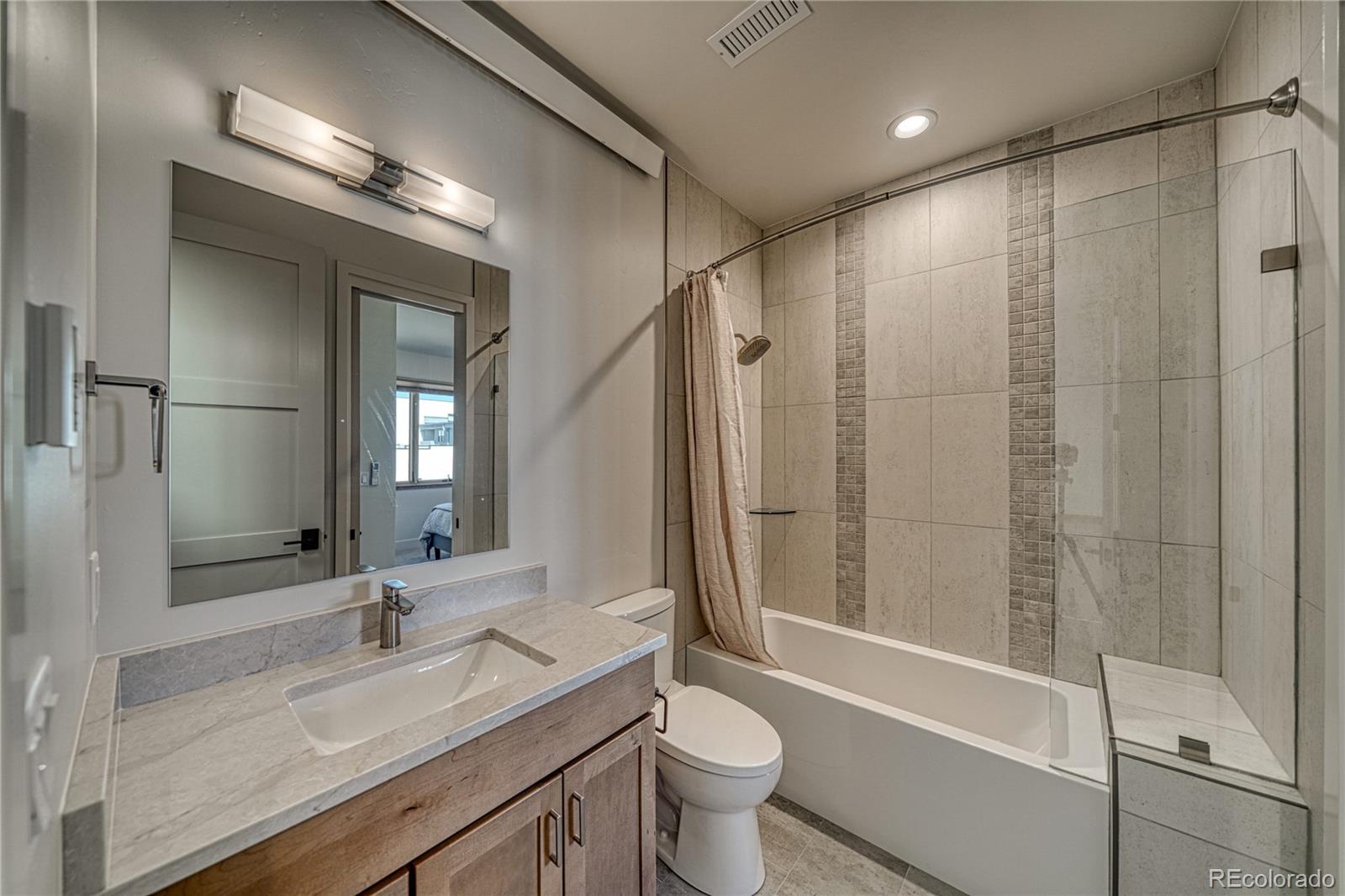 205 Two Rivers Road, Unit G Salida, CO 81201 - Photo 18 of 29 a bathroom with a double vanity sink toilet mirror and bathtub
