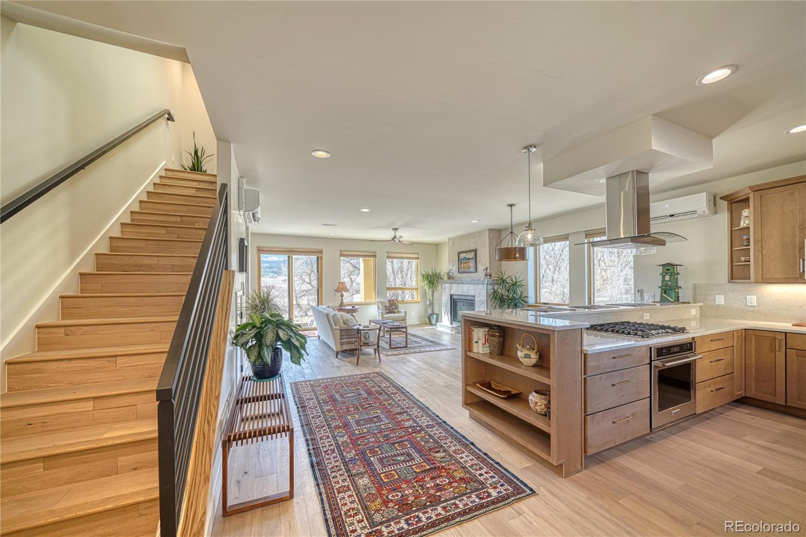 205 Two Rivers Road, Unit G Salida, CO 81201 - Photo 6 of 29 a kitchen with stainless steel appliances granite countertop a stove a sink and a wooden floors