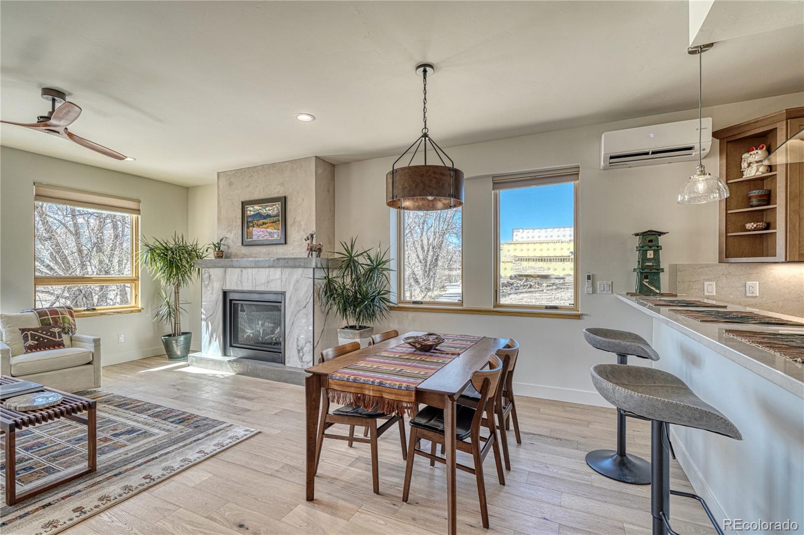 205 Two Rivers Road, Unit G Salida, CO 81201 - Photo 9 of 29 a dining room with furniture a chandelier and wooden floor