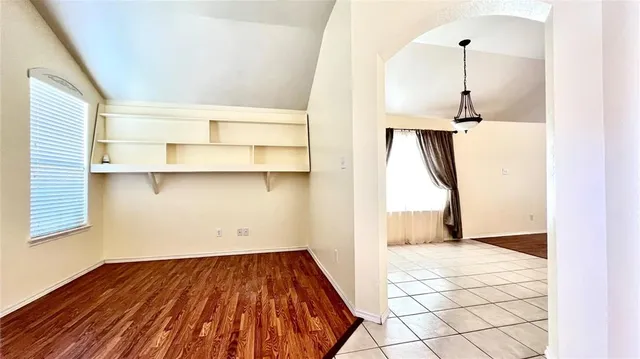 a view of a room with wooden floor and cabinet