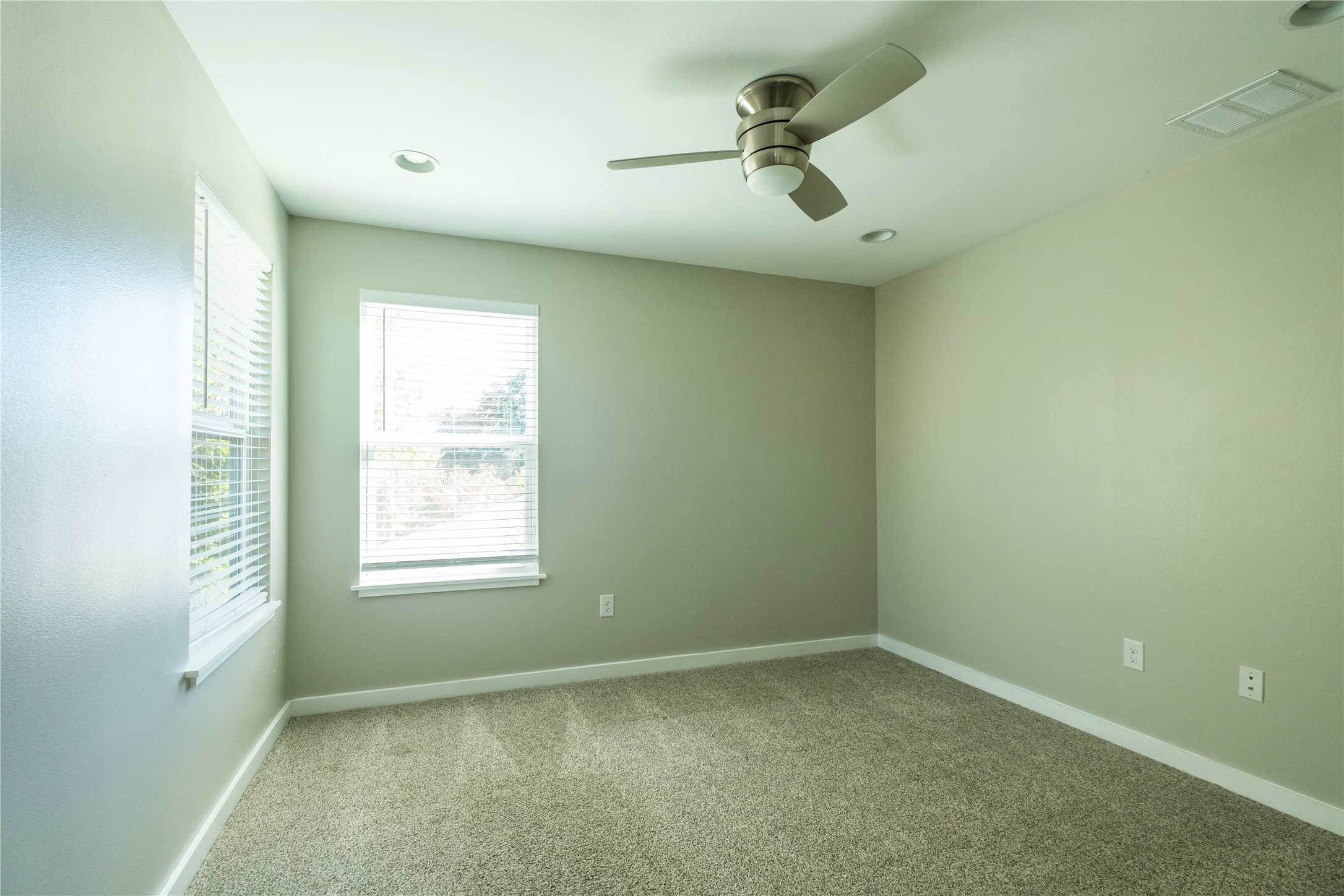 7601 Bethune Avenue, Unit B Austin, TX 78752 - Photo 18 of 39 Empty room featuring carpet, ceiling fan, and recessed lighting