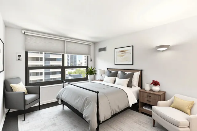 a bedroom with a bed and a large window