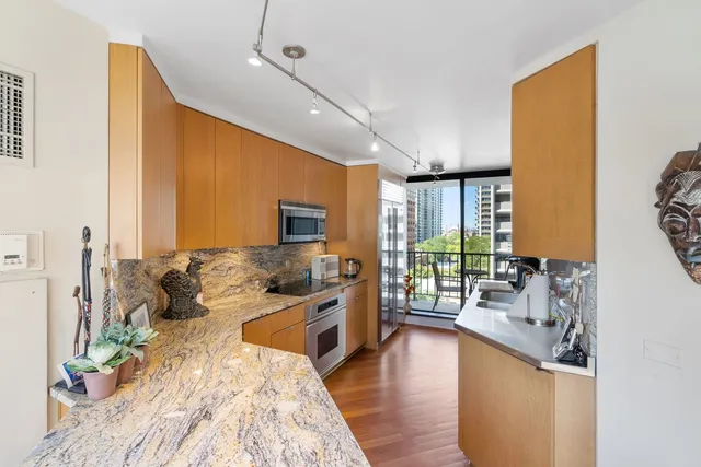a very nice looking living room with a large window and wooden floor