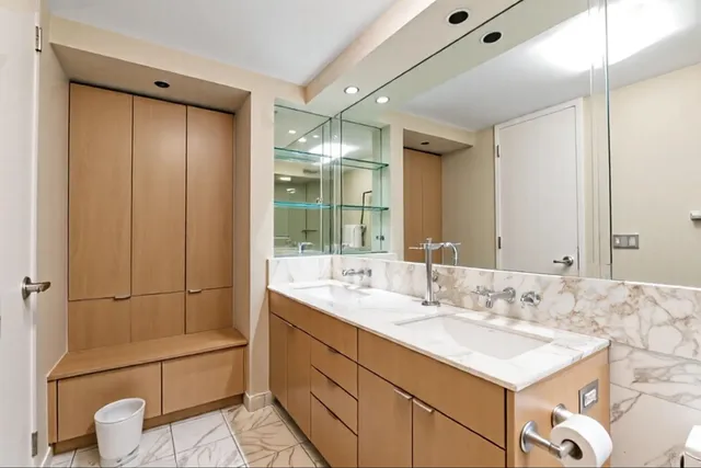a bathroom with a sink shower and a mirror