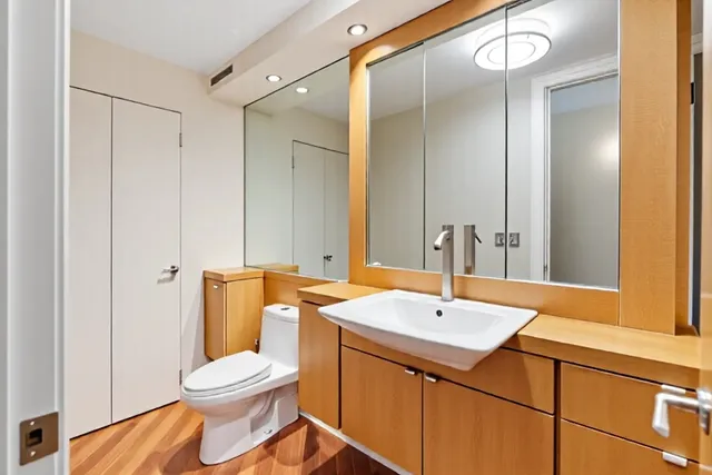 a bathroom with a toilet a sink and a mirror