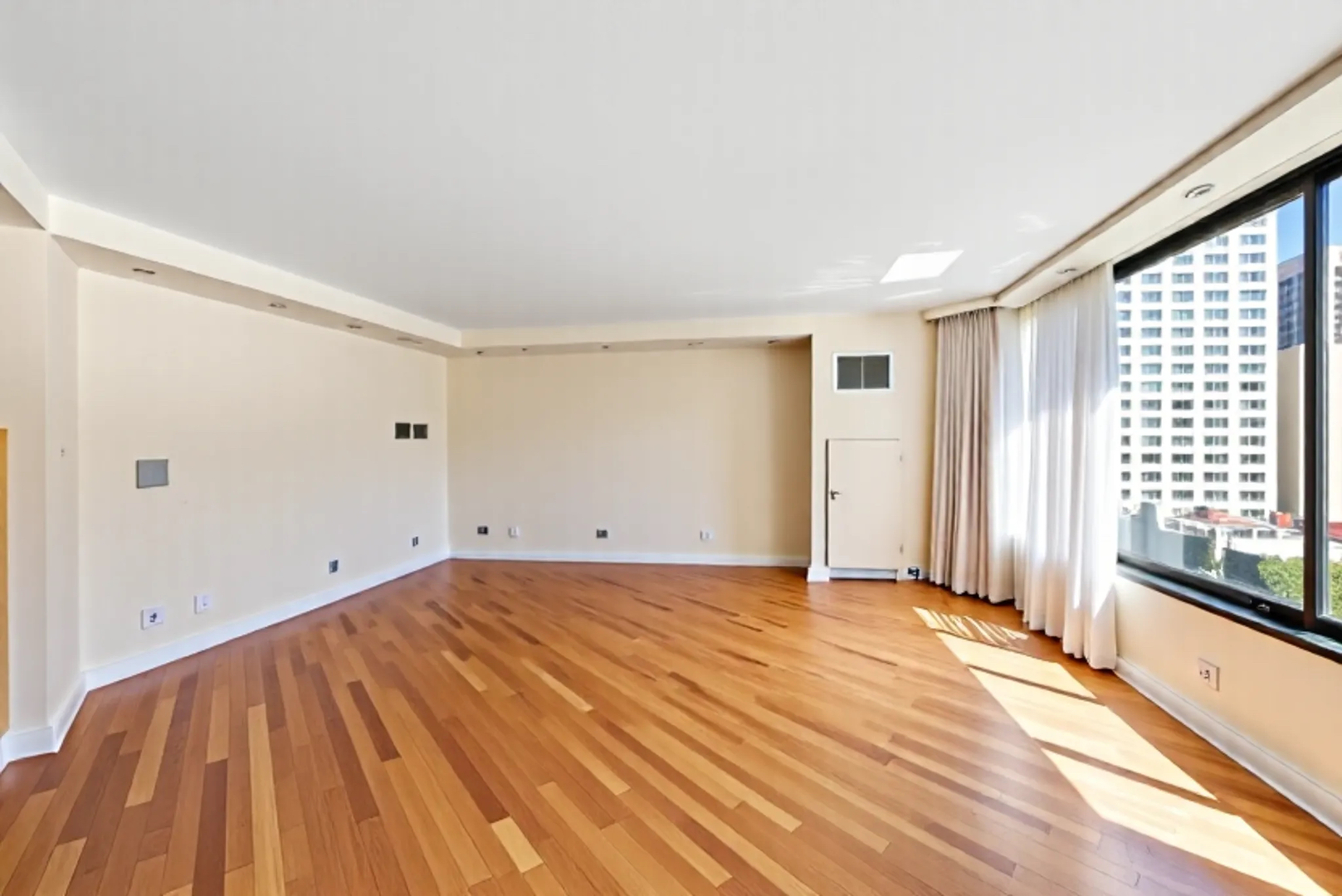 1410 North State Parkway, Unit 10B Chicago, IL 60610 - Photo 5 of 25 a view of empty room with wooden floor and fan